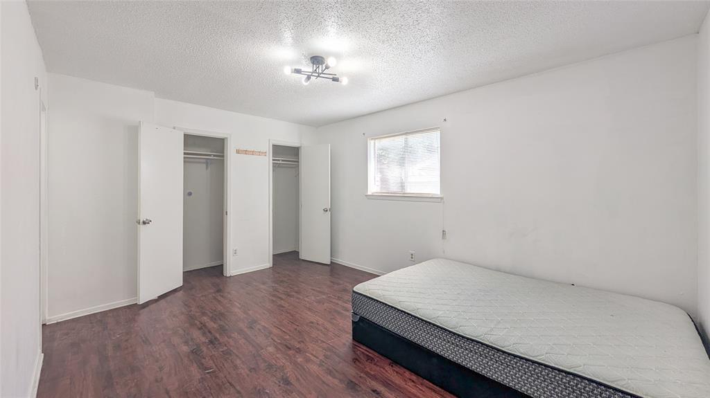 1107 Waverly Drive Arlington, TX 76015 - Photo 3 of 20 wooden floor in an empty room with a window