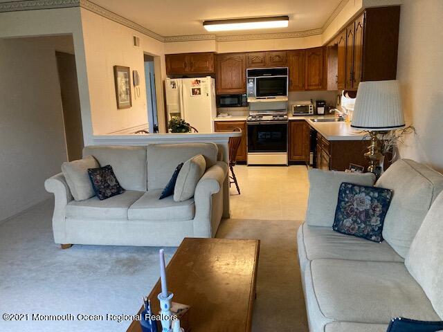 40 Rainier Drive Brick, NJ 08724 - Photo 16 of 25 a living room with furniture flat screen tv and a fireplace
