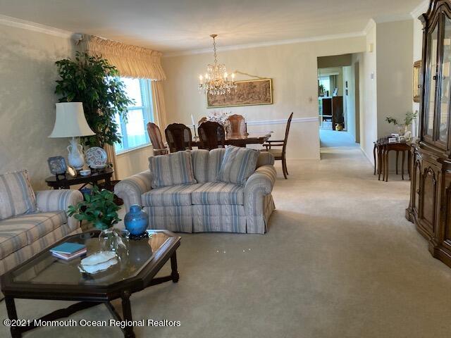 40 Rainier Drive Brick, NJ 08724 - Photo 7 of 25 a living room with furniture and a chandelier