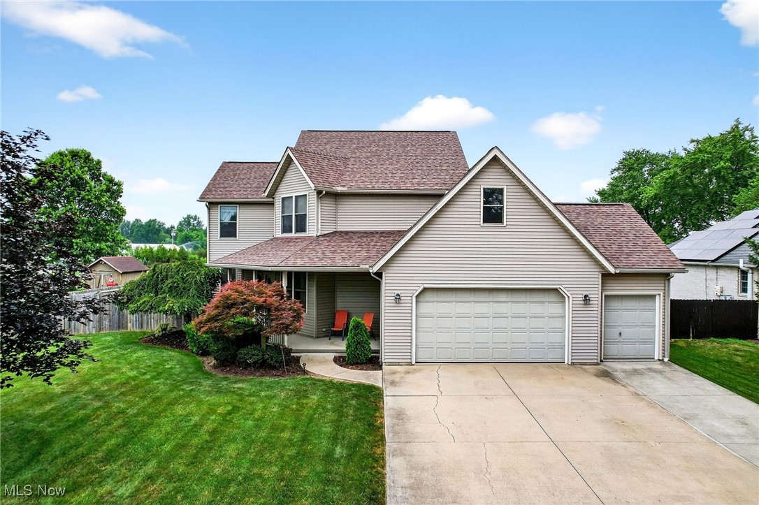 35748 Mills Road Avon, OH 44011 - Photo 2 of 44 Traditional-style home with concrete driveway, a shingled roof, a porch, and a garage