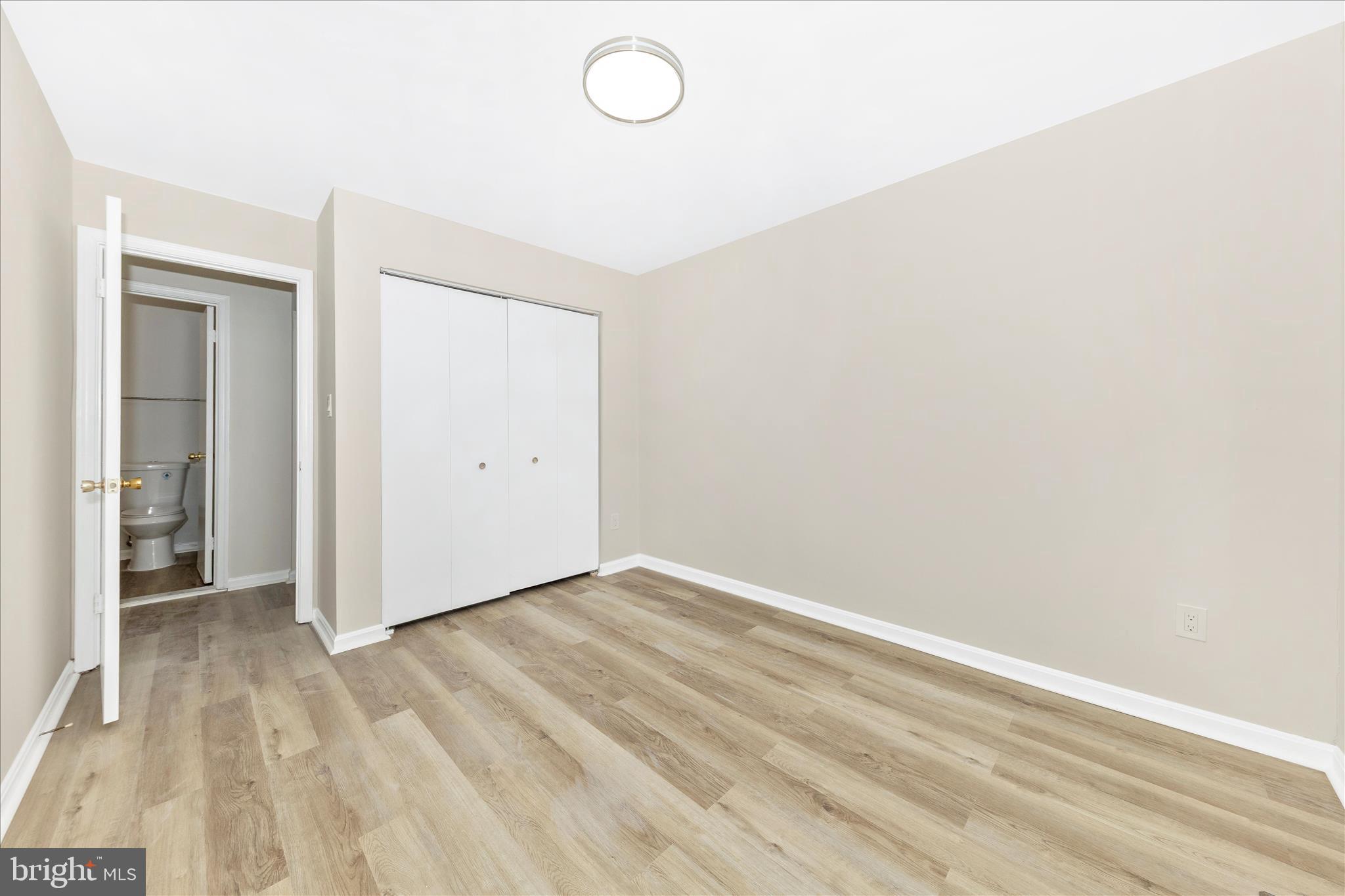 1 Kinsman View Circle Silver Spring, MD 20901 - Photo 25 of 52 an empty room with wooden floor and windows