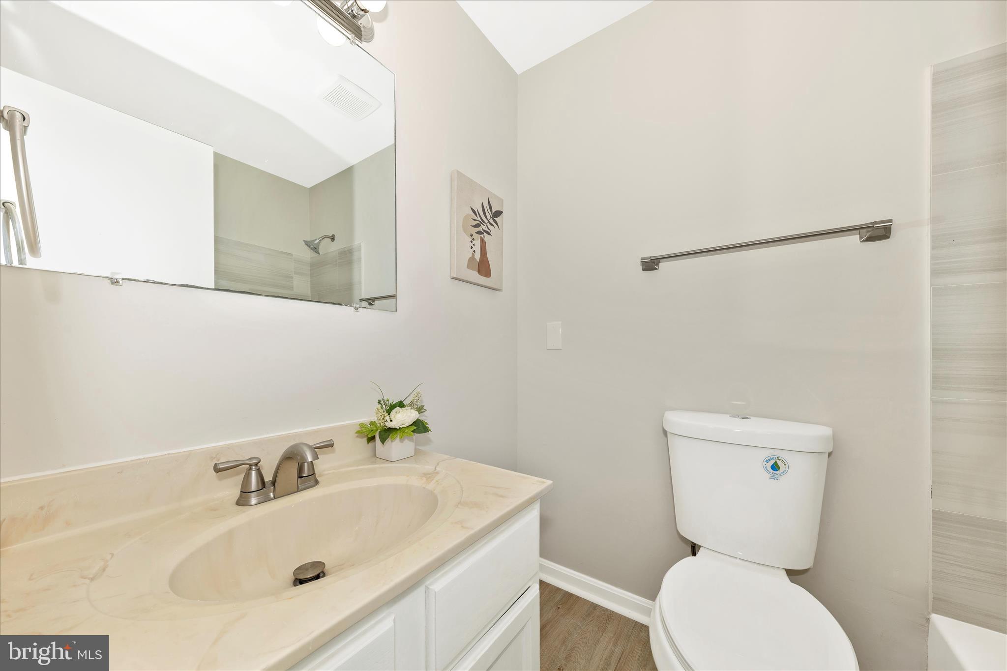 1 Kinsman View Circle Silver Spring, MD 20901 - Photo 26 of 52 a bathroom with a toilet sink and mirror
