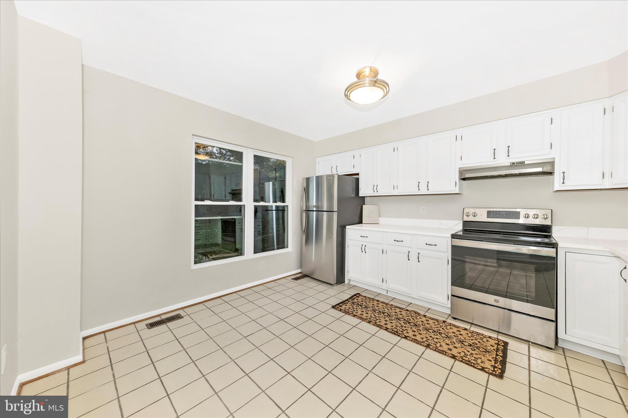 1 Kinsman View Circle Silver Spring, MD 20901 - Photo 3 of 52 a kitchen with a stove a sink and a refrigerator