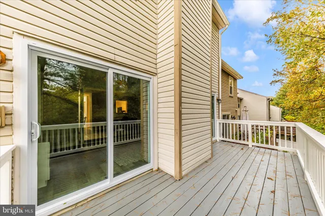 a view of balcony with wooden floor and fence