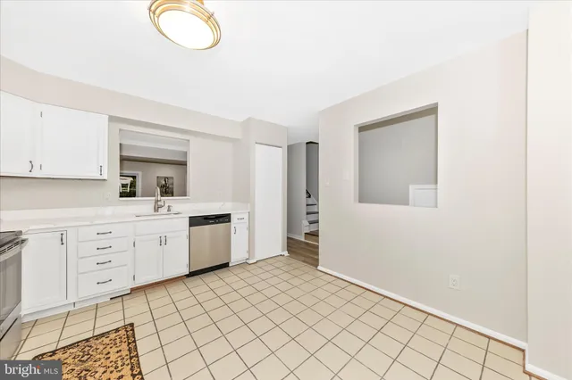 a large white kitchen with white cabinets
