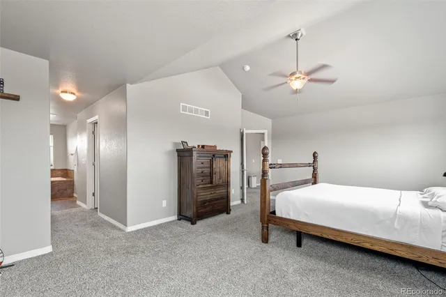 a bed room with a bed and a chandelier