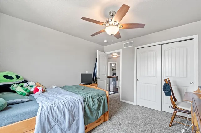 a bathroom with a granite countertop sink a toilet and a window
