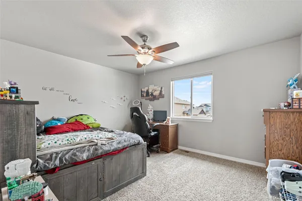 a bedroom with bed and a chandelier
