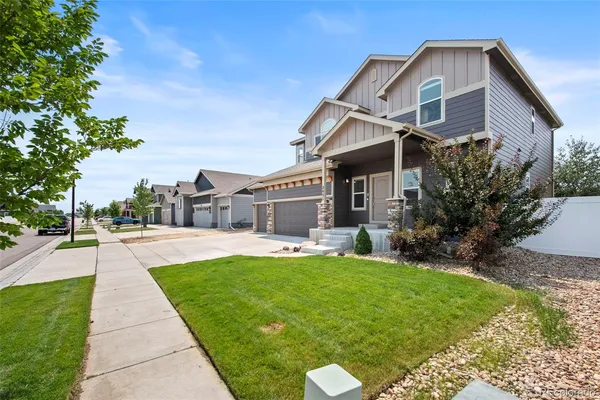 a front view of a house with a yard and porch