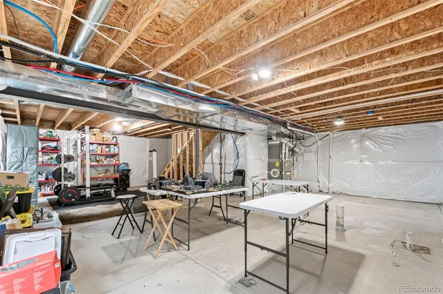 a patio with table and chairs and potted plants