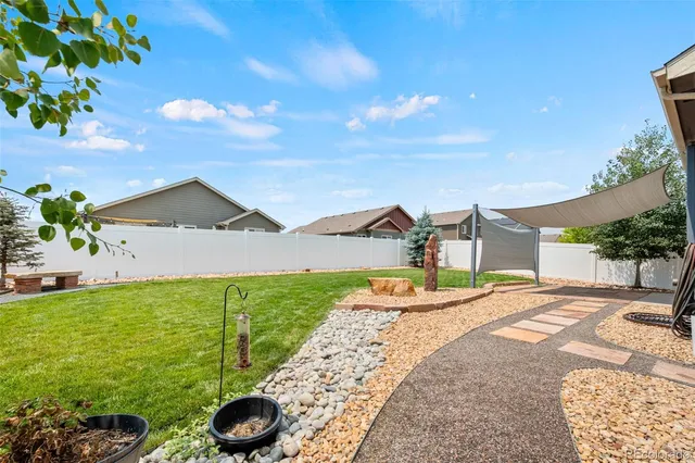 a front view of house with yard and outdoor seating