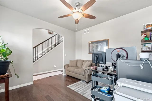 a living room with furniture and wooden floor