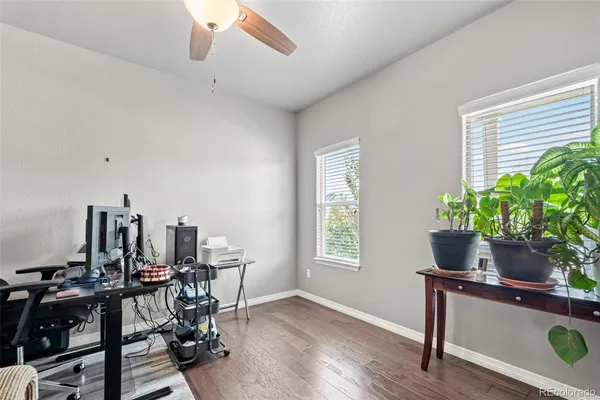 a view of a workspace with furniture and a window