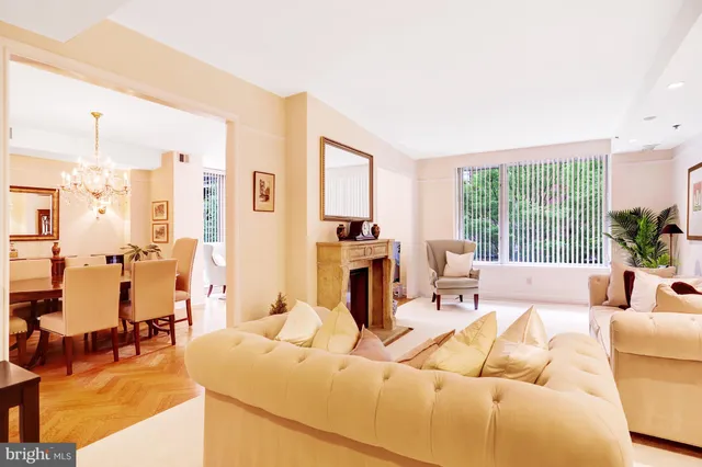 a living room with furniture and large windows