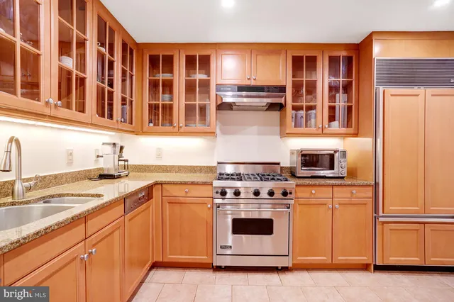 a kitchen with stainless steel appliances granite countertop a stove and a refrigerator