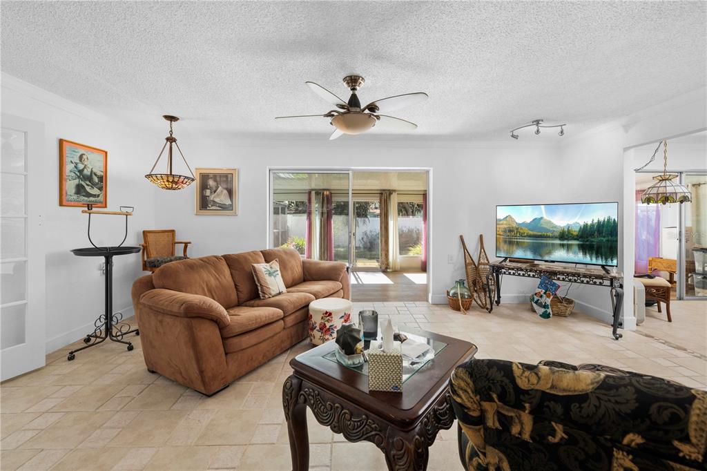 5122 Bay Boulevard Port Richey, FL 34668 - Photo 13 of 56 a living room with furniture a flat screen tv and a window