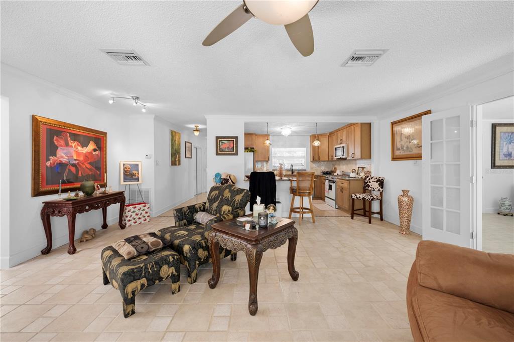 5122 Bay Boulevard Port Richey, FL 34668 - Photo 16 of 56 a living room with furniture kitchen view and a flat screen tv