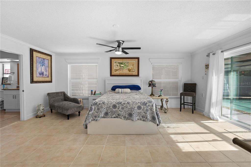 5122 Bay Boulevard Port Richey, FL 34668 - Photo 20 of 56 a spacious bedroom with a bed and glass window