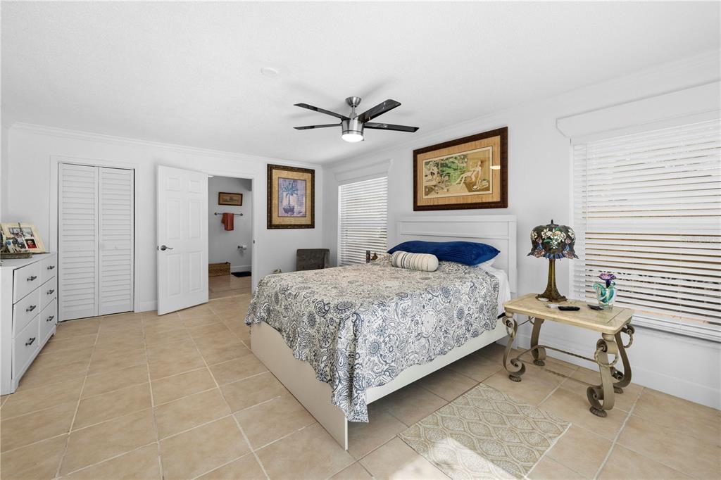 5122 Bay Boulevard Port Richey, FL 34668 - Photo 22 of 56 a bedroom with a bed and a table in it