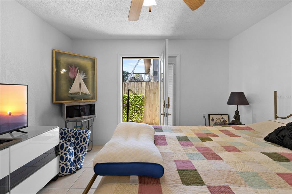 5122 Bay Boulevard Port Richey, FL 34668 - Photo 42 of 56 a bedroom with a bed and a flat screen tv