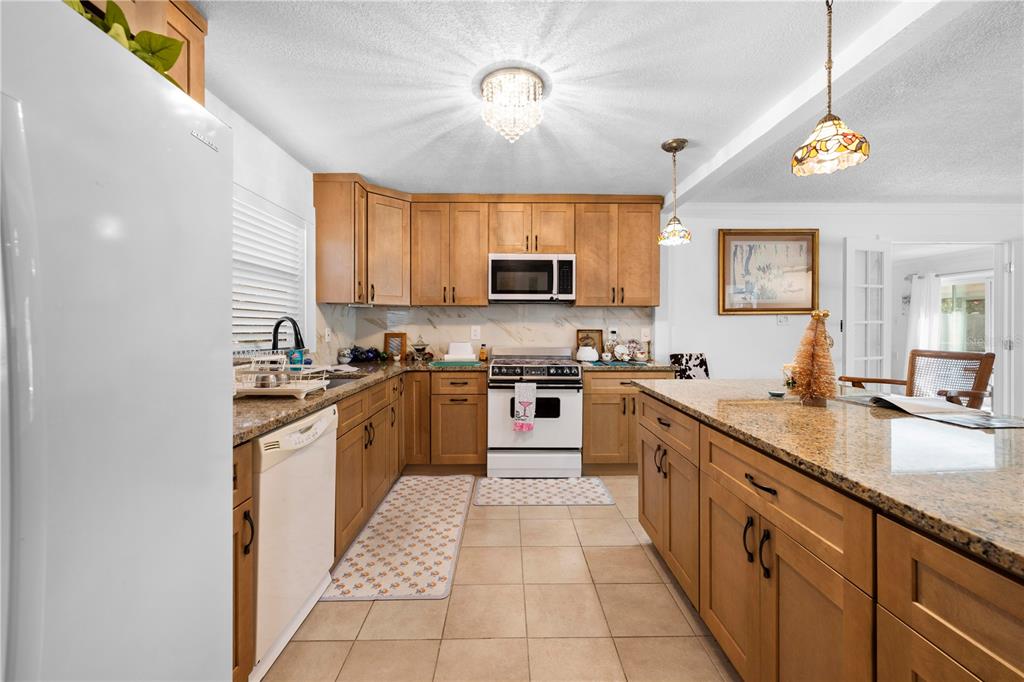 5122 Bay Boulevard Port Richey, FL 34668 - Photo 6 of 56 a kitchen with stainless steel appliances granite countertop a sink and cabinets