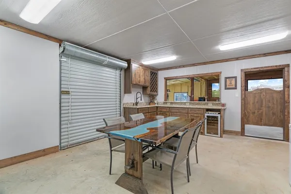 a bathroom with a granite countertop sink a large mirror and a window