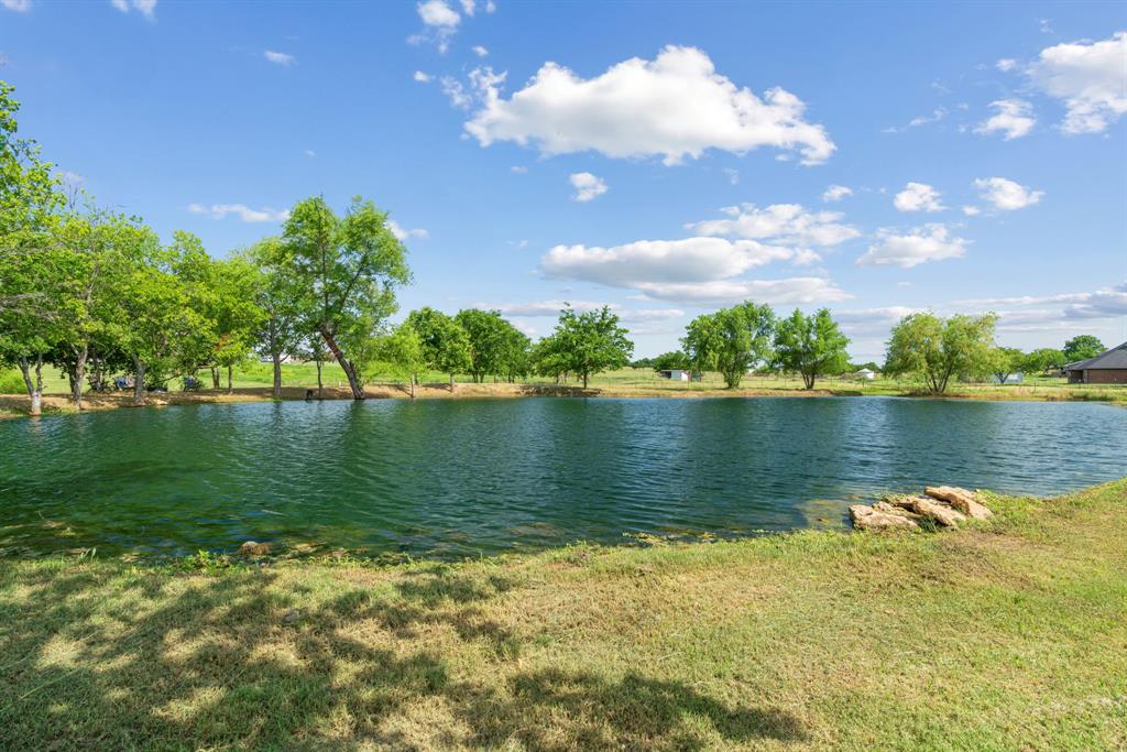 12190 Marion Road Sanger, TX 76266 - Photo 37 of 39 a view of a lake with houses in the background