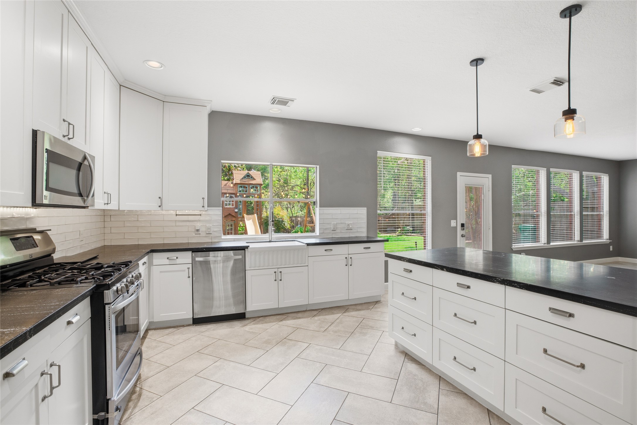 20907 Nettlebrook Lane Katy, TX 77450 - Photo 12 of 46 The kitchen sits right where it should, open, accessible, and part of the rhythm of the home. Pendant lights drop softly over the breakfast bar, creating a natural place to gather.