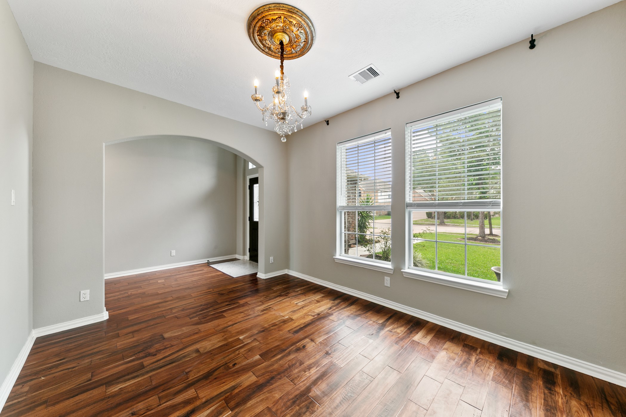 9438 Emerald Lakes Drive Rosharon, TX 77583 - Photo 3 of 36 a view of an empty room with a window and wooden floor