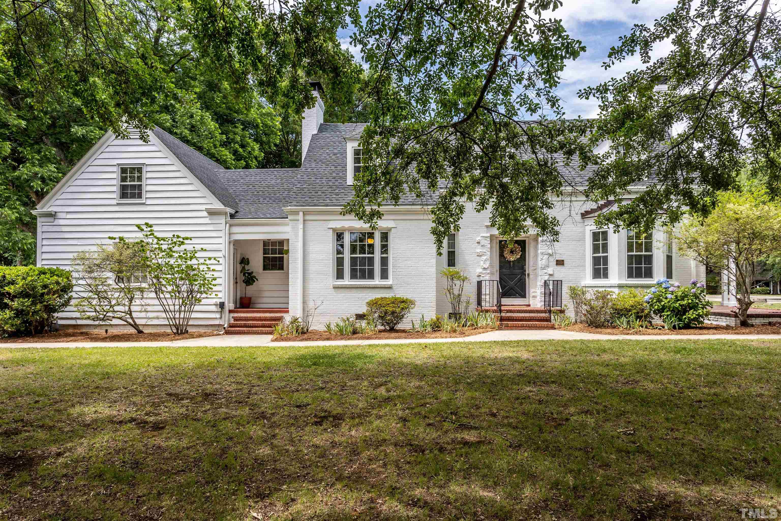 a house that has a tree in front of it