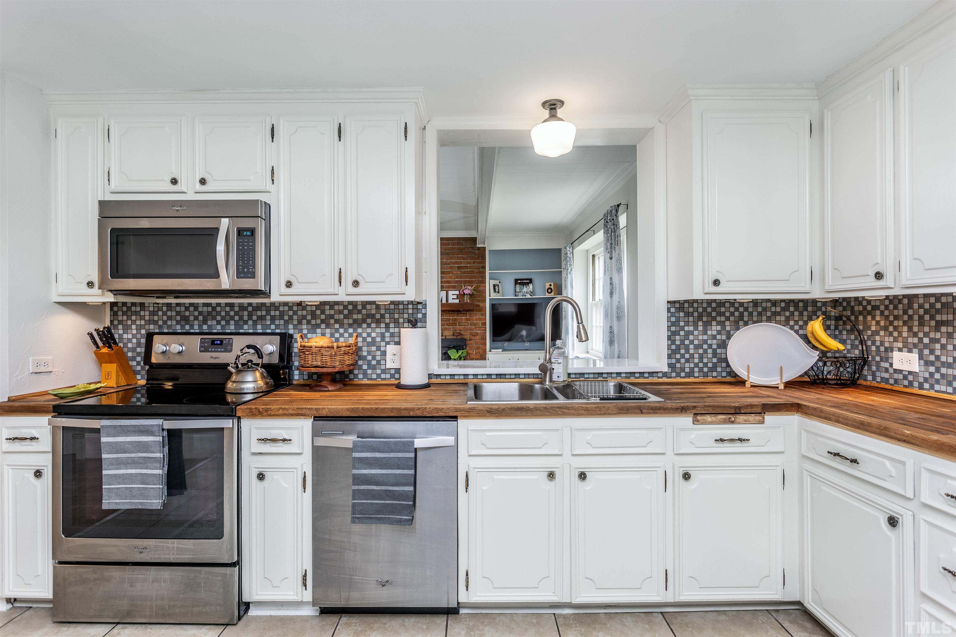 2019 New Bern Avenue Raleigh, NC 27610 - Photo 13 of 37 a kitchen with stainless steel appliances granite countertop a sink stove and cabinets