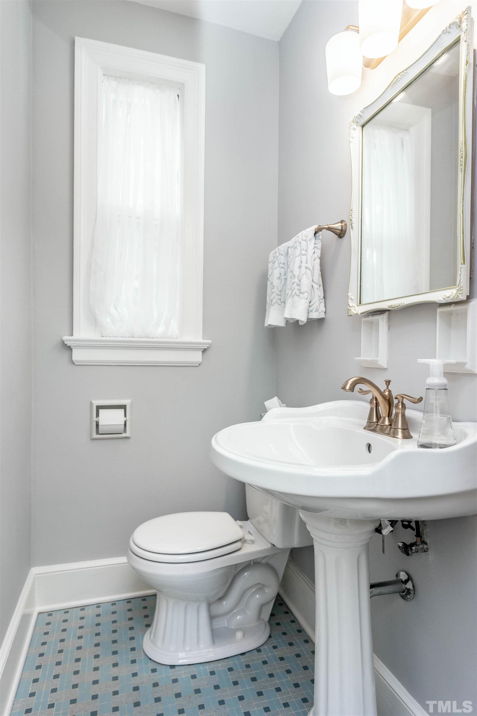 2019 New Bern Avenue Raleigh, NC 27610 - Photo 15 of 37 a bathroom with a sink toilet and mirror