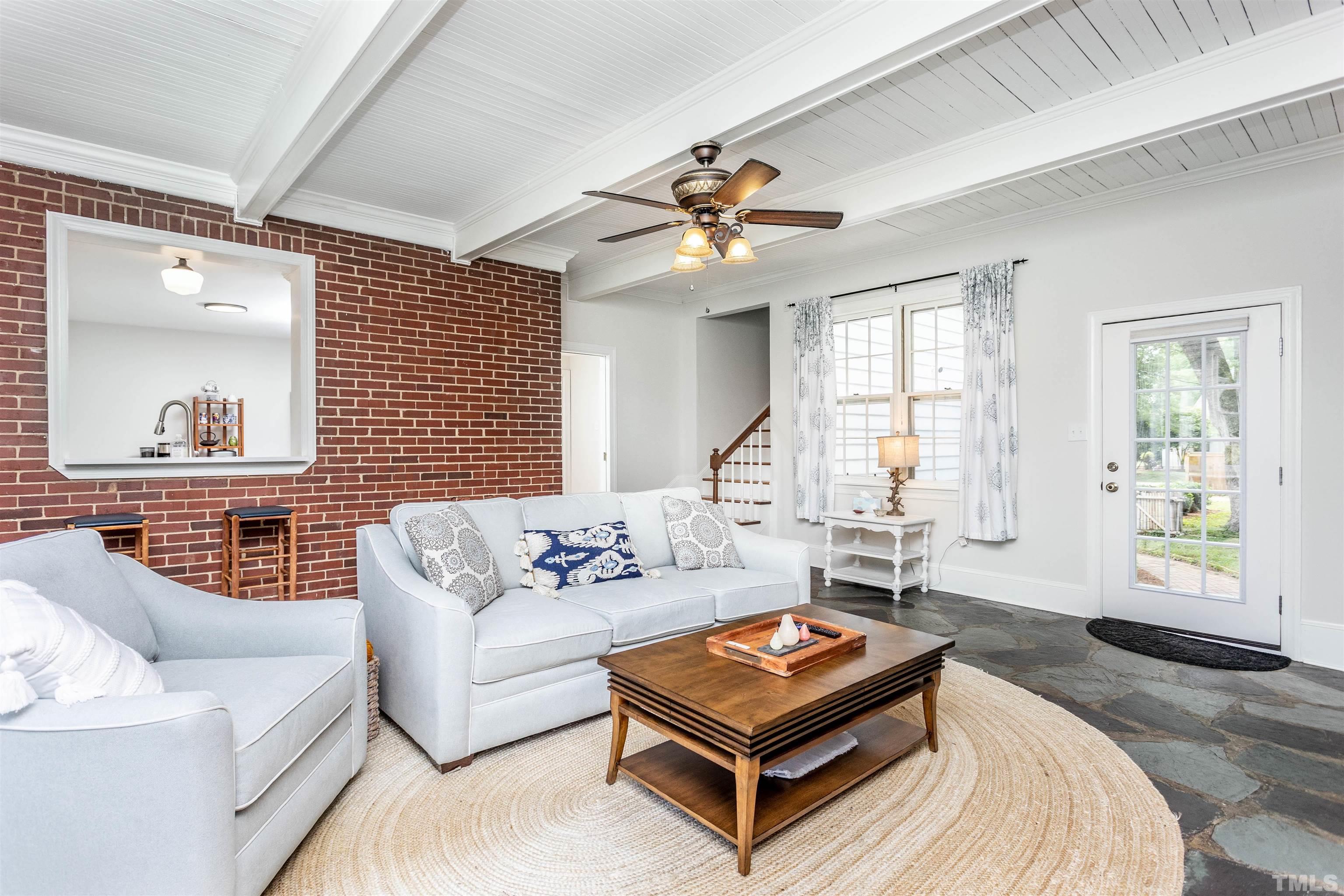 2019 New Bern Avenue Raleigh, NC 27610 - Photo 17 of 37 a living room with furniture a table and a large window