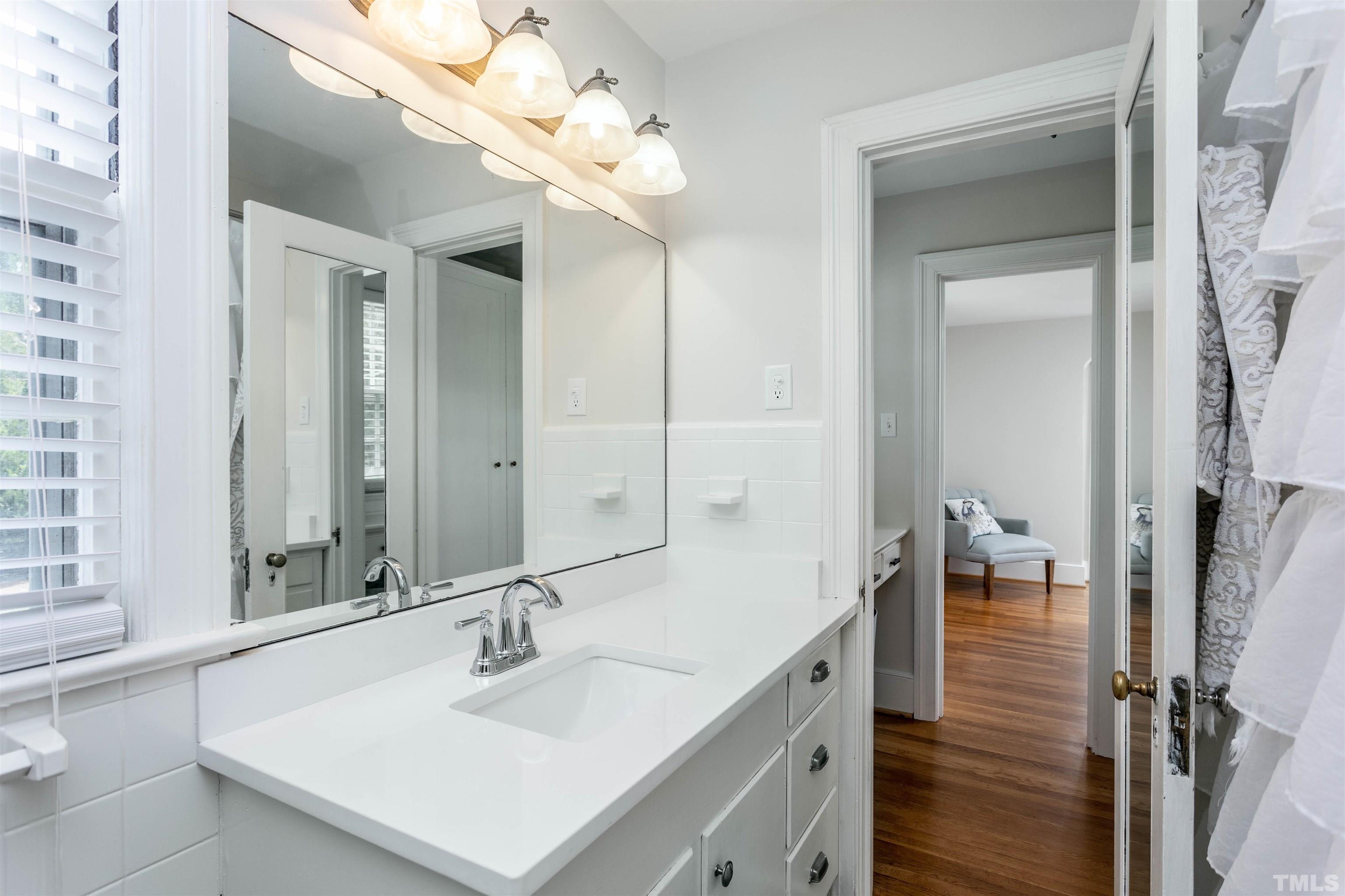 2019 New Bern Avenue Raleigh, NC 27610 - Photo 22 of 37 a bathroom with a sink vanity and a mirror