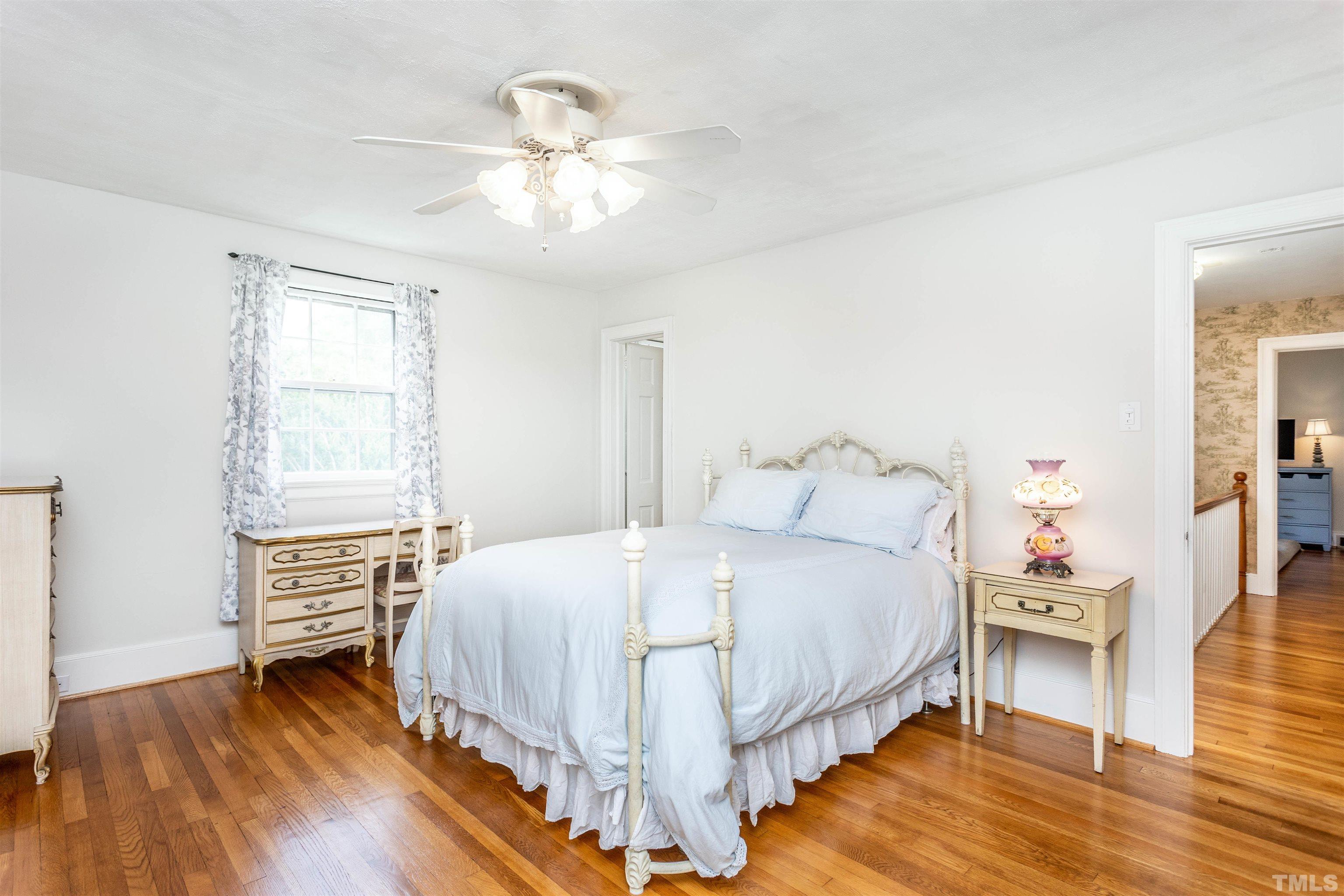 2019 New Bern Avenue Raleigh, NC 27610 - Photo 27 of 37 a bedroom with a bed and a chandelier