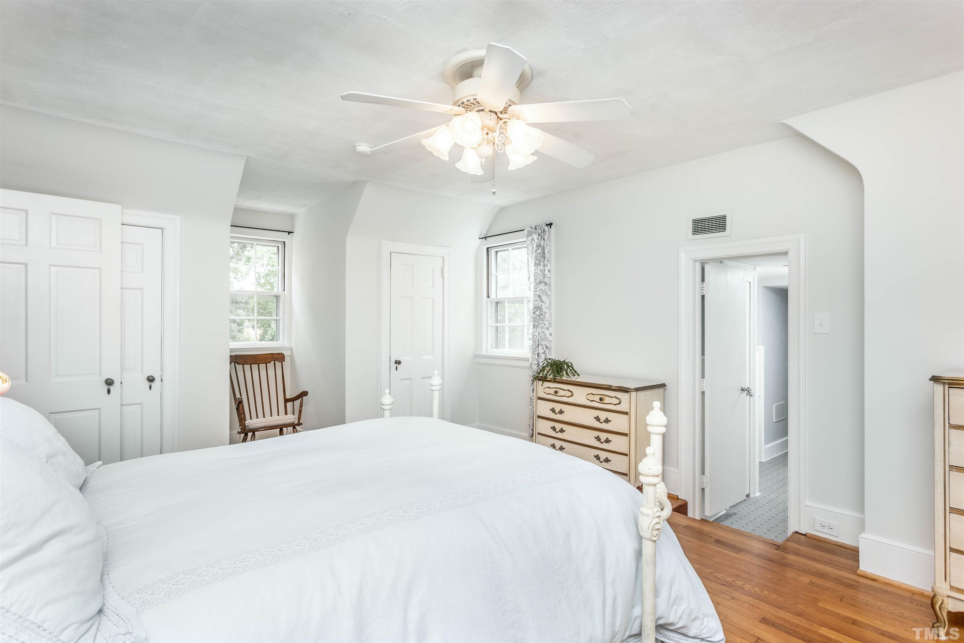 2019 New Bern Avenue Raleigh, NC 27610 - Photo 28 of 37 a bedroom with a bed and a chandelier