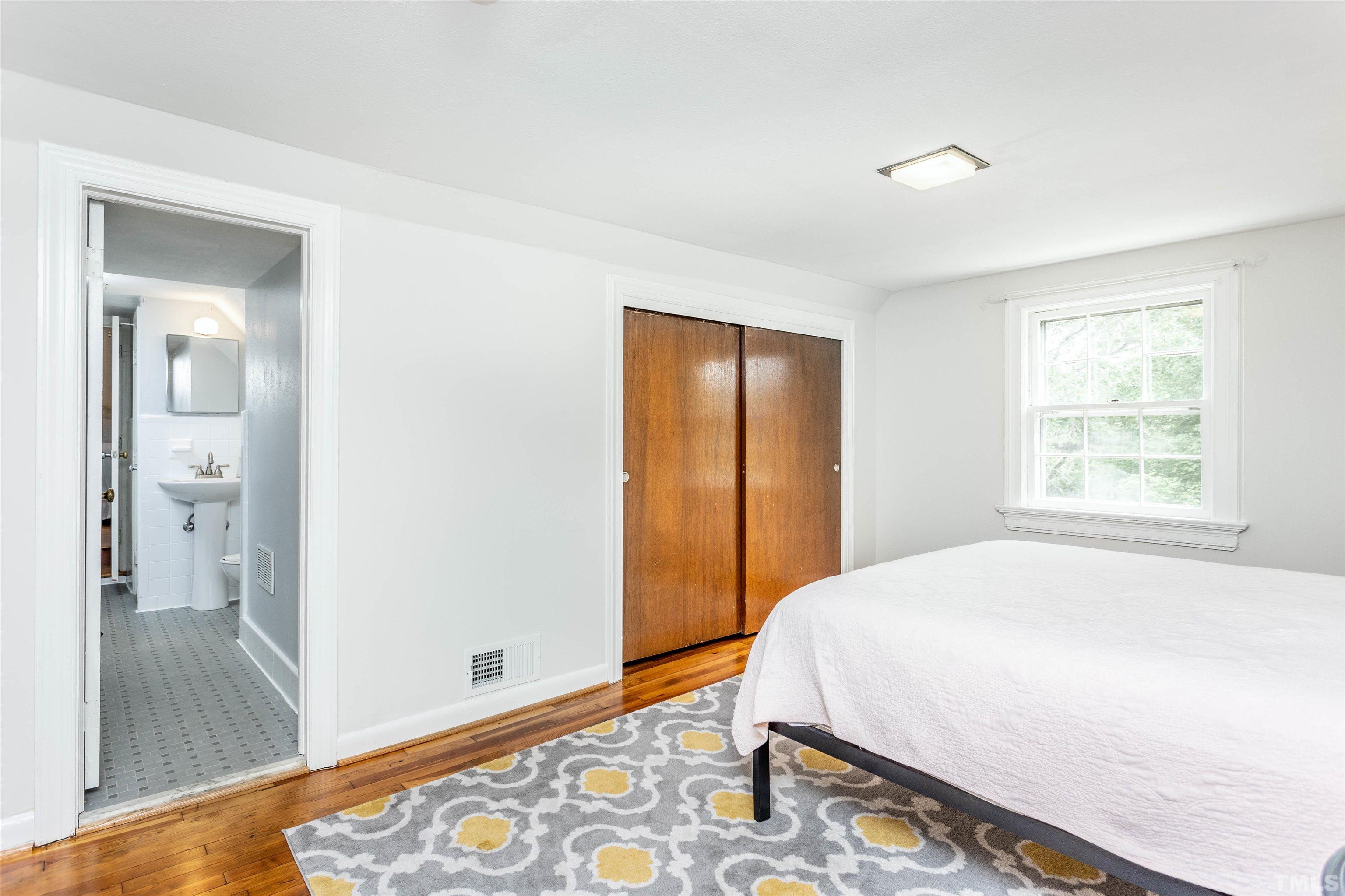 2019 New Bern Avenue Raleigh, NC 27610 - Photo 29 of 37 a bedroom with a bed and a window