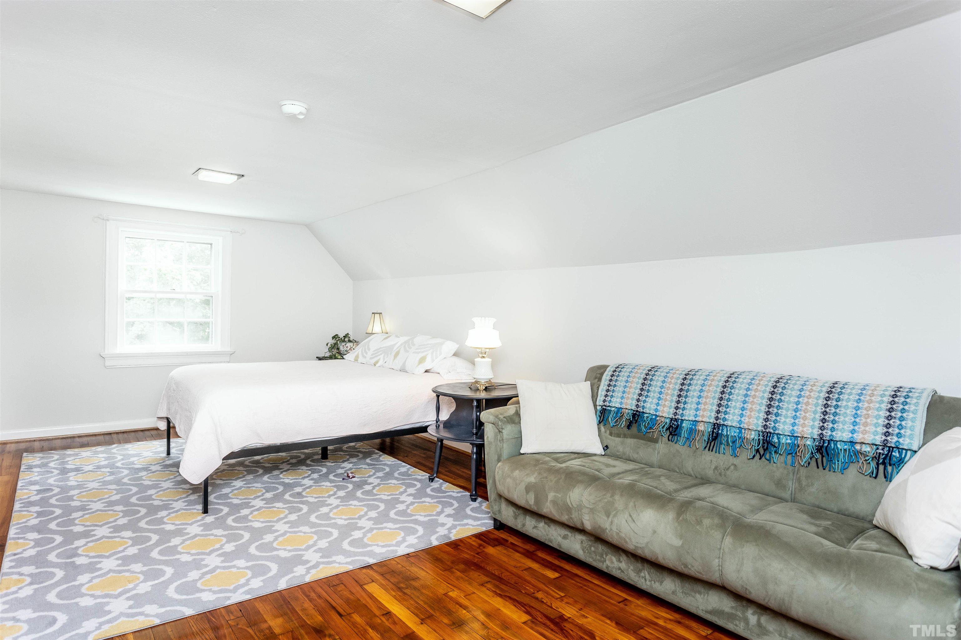 2019 New Bern Avenue Raleigh, NC 27610 - Photo 30 of 37 a bedroom with a bed and wooden floor