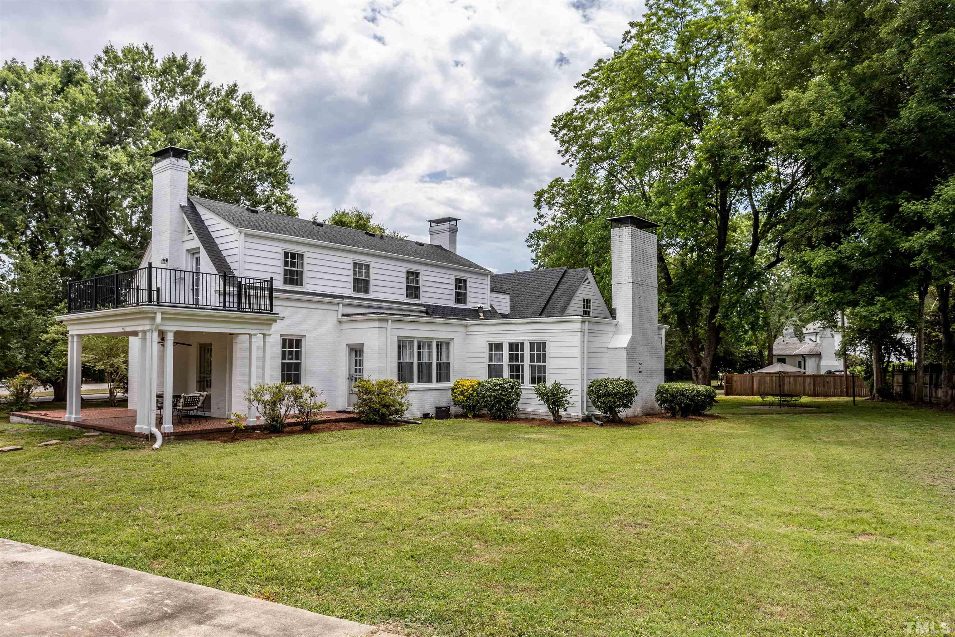 2019 New Bern Avenue Raleigh, NC 27610 - Photo 4 of 37 a front view of a house with a garden and trees