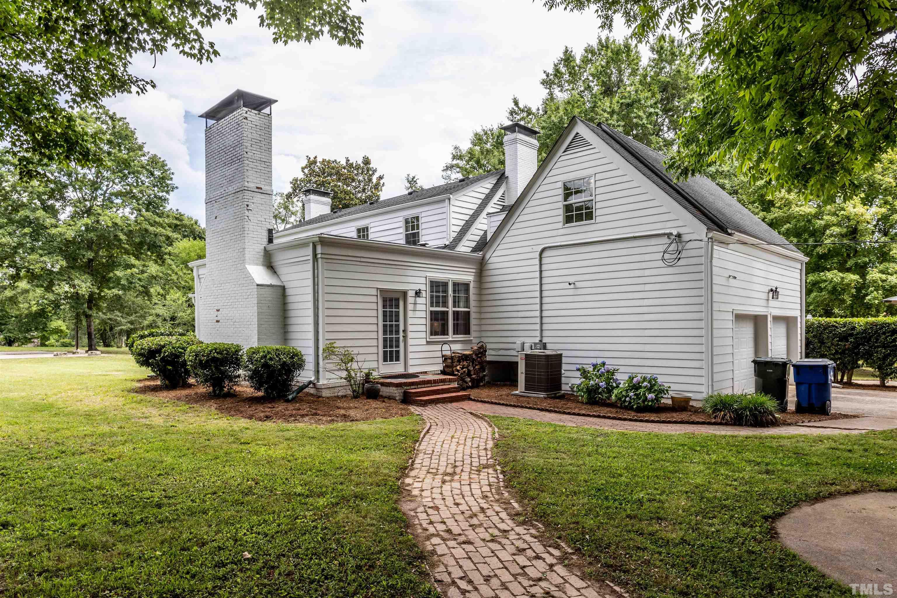 2019 New Bern Avenue Raleigh, NC 27610 - Photo 5 of 37 a front view of a house with a yard and potted plants