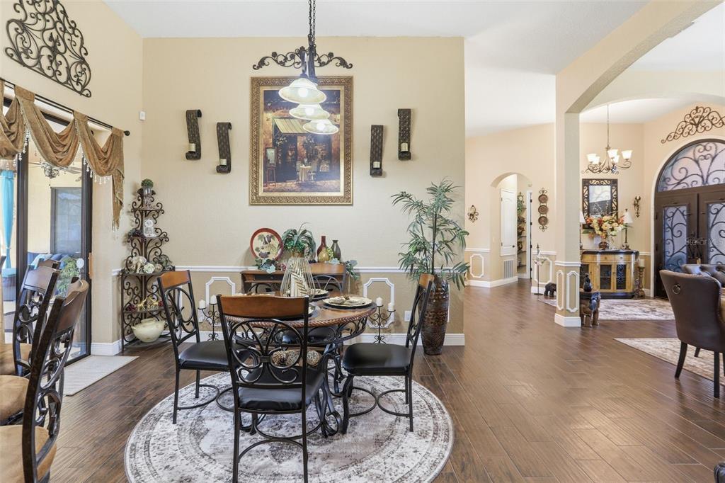 13429 Montevista Road Clermont, FL 34711 - Photo 16 of 89 a view of a dining room with furniture and wooden floor