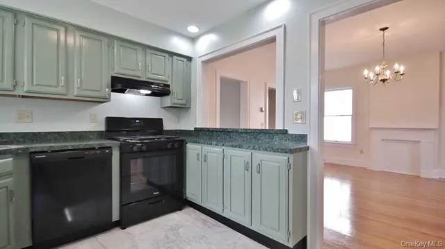 a kitchen with stainless steel appliances granite countertop a stove and a refrigerator