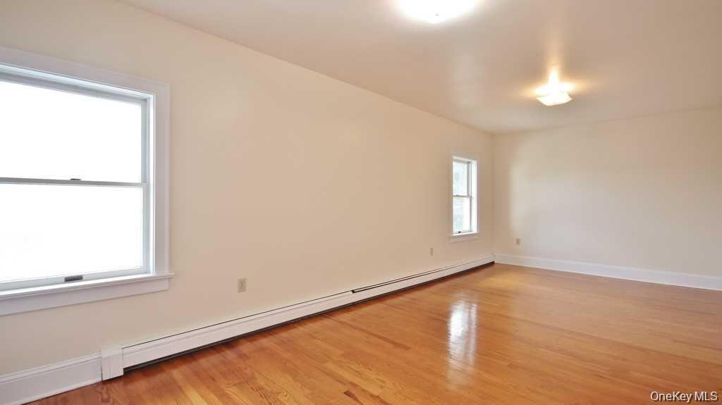 40 Broad Street Fishkill, NY 12524 - Photo 17 of 23 a view of an empty room with wooden floor and a window