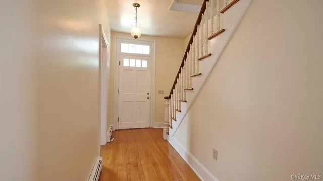 a view of entryway with wooden floor