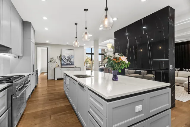 a large kitchen with kitchen island a sink and a stove