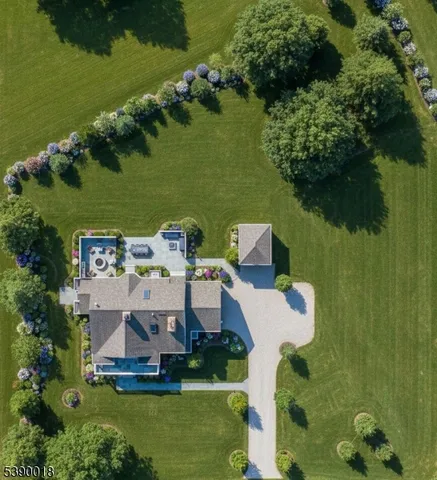 an aerial view of a house with a yard basket ball court and outdoor seating