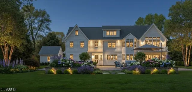 a front view of a house with a yard and lake view