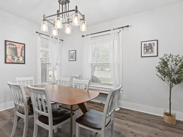 a view of a dining room with furniture and wooden floor