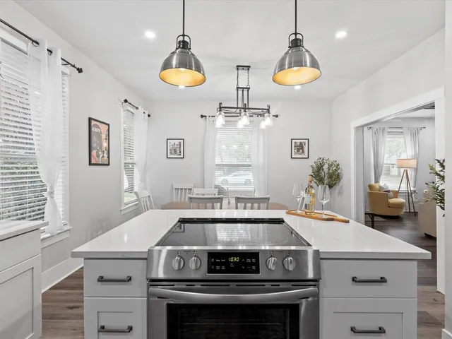a kitchen with a stove and a chandelier