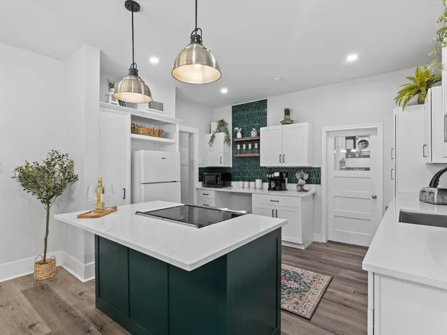 a kitchen with stainless steel appliances a center island and cabinets